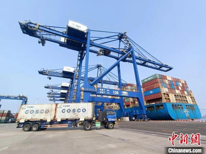 圖為海南洋浦國(guó)際集裝箱碼頭，卡車將集裝箱從后方堆場(chǎng)運(yùn)往碼頭裝卸區(qū)?！?jiān)潞?攝