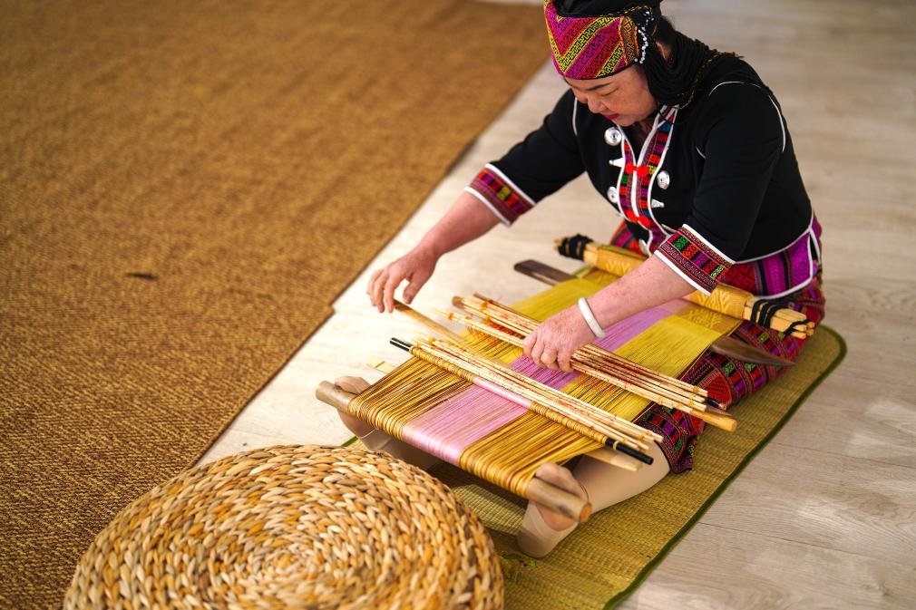 4月17日，黎族傳統(tǒng)紡染織繡技藝國家級代表性傳承人劉香蘭在2023年意大利米蘭設計周上展示黎錦織造技藝。新華社發(fā)
