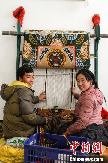 圖為1月15日，在日喀則市謝瑪氆氌農(nóng)村合作社，拉孜村一對(duì)夫婦在編織卡墊(資料圖)。　趙朗 攝