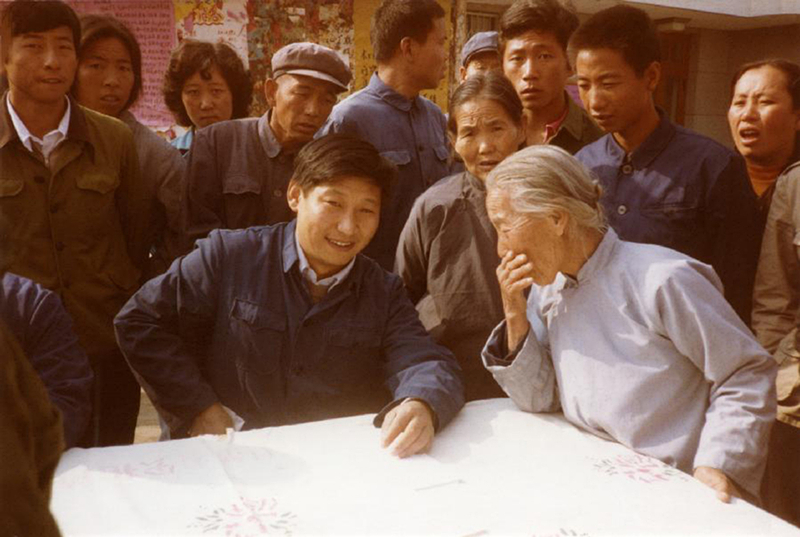 1983年，時(shí)任河北正定縣委書(shū)記的習(xí)近平（前排居中），臨時(shí)在大街上擺桌子聽(tīng)取老百姓意見(jiàn)。