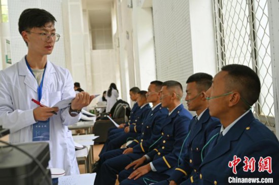 圖為研究團(tuán)隊(duì)成員登記消防員信息。　趙朗 攝