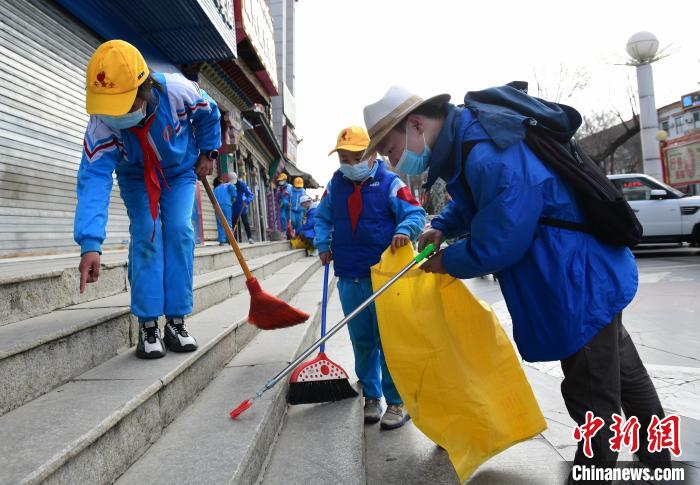 圖為拉薩市小學(xué)生打掃街道?！∝暩聛硭?攝